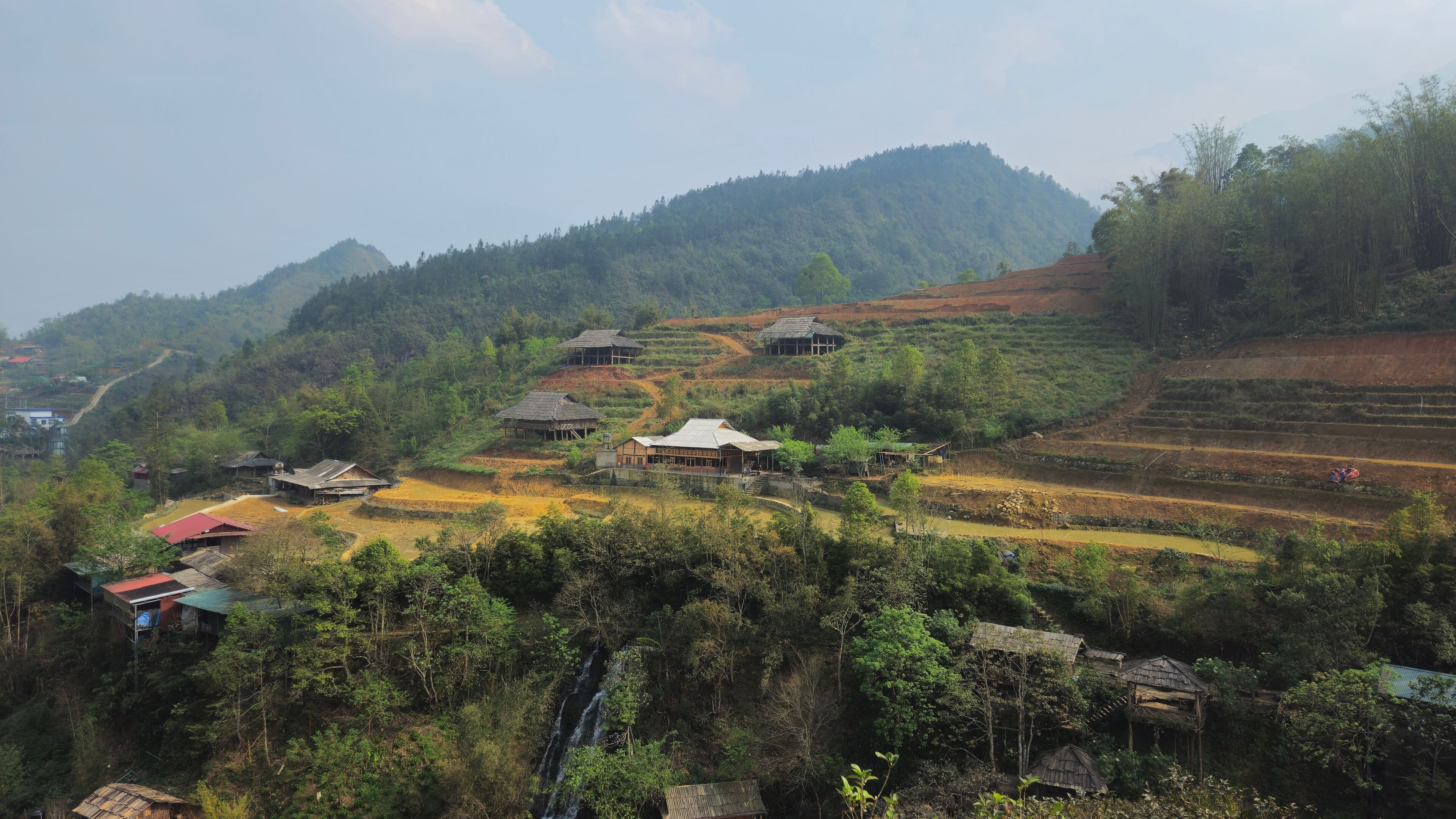 Hills, mountain, terraced fields and traditional houses in Sapa town, lao Cai province, Vietnam in the afternoon with fog.