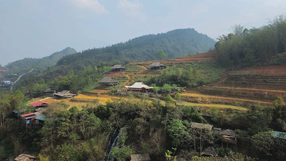 Hills, mountain, terraced fields and traditional houses in Sapa town, lao Cai province, Vietnam in the afternoon with fog.