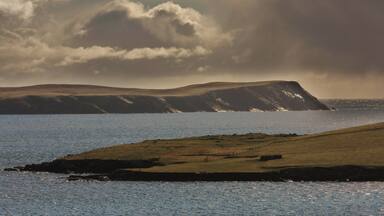 Levenwick Ness and distant No Ness in the morning light.