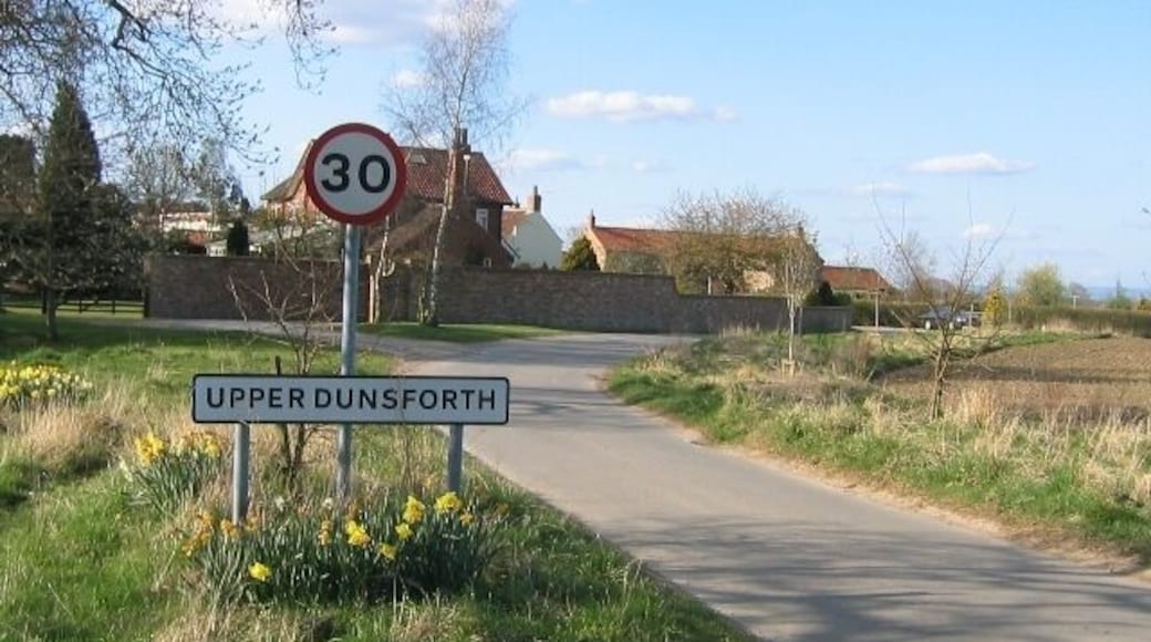 Upper Dunsforth Entering the village of Upper Dunsforth from the south east. Where the road curves left by the car it becomes square SE4463.