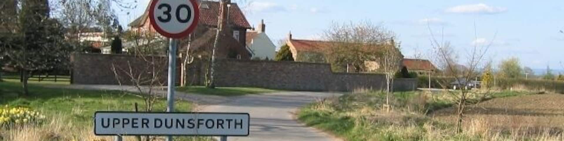 Upper Dunsforth Entering the village of Upper Dunsforth from the south east. Where the road curves left by the car it becomes square SE4463.