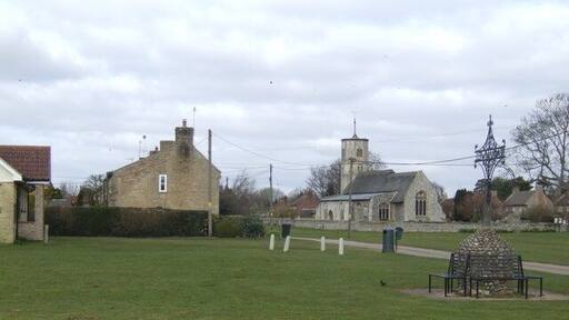 The village green, Beachamwell Featuring an elaborate wrought-iron village sign.