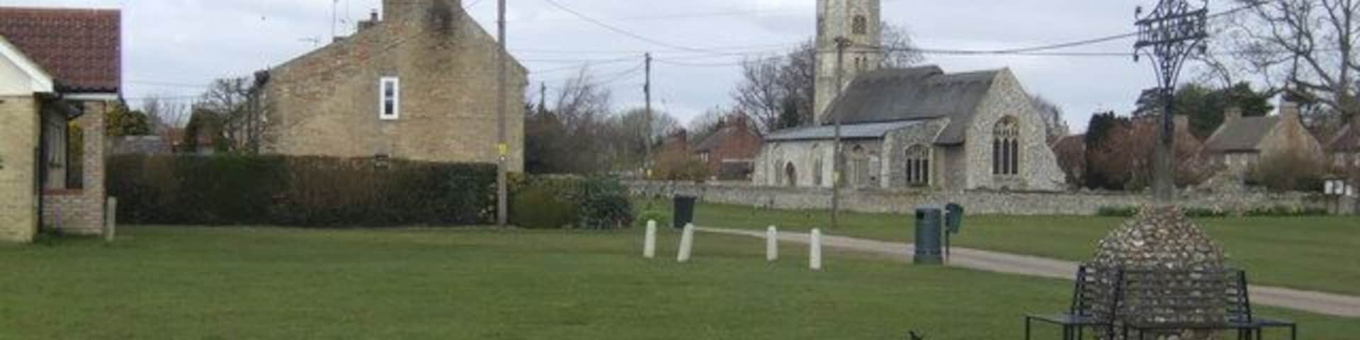 The village green, Beachamwell Featuring an elaborate wrought-iron village sign.