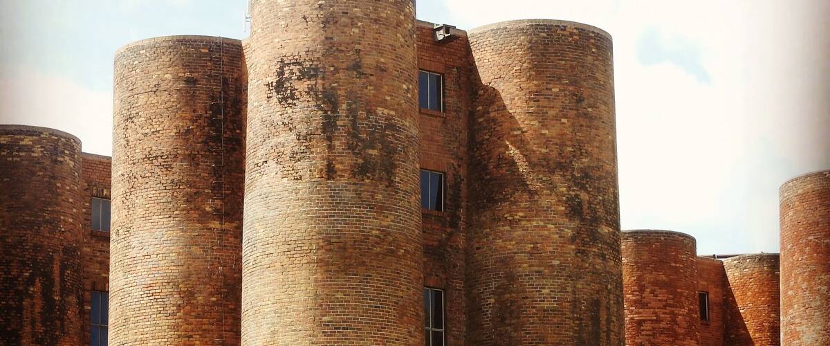 A row of tall brick towers with windows.