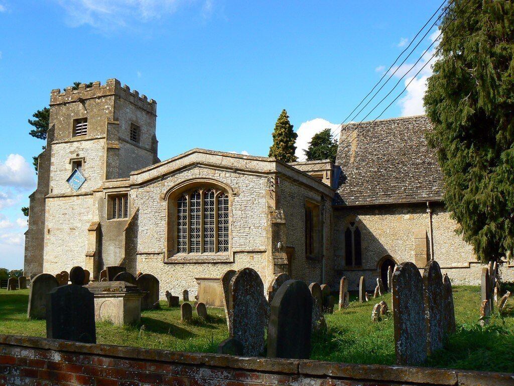 A historic church with a tower and a graveyard.