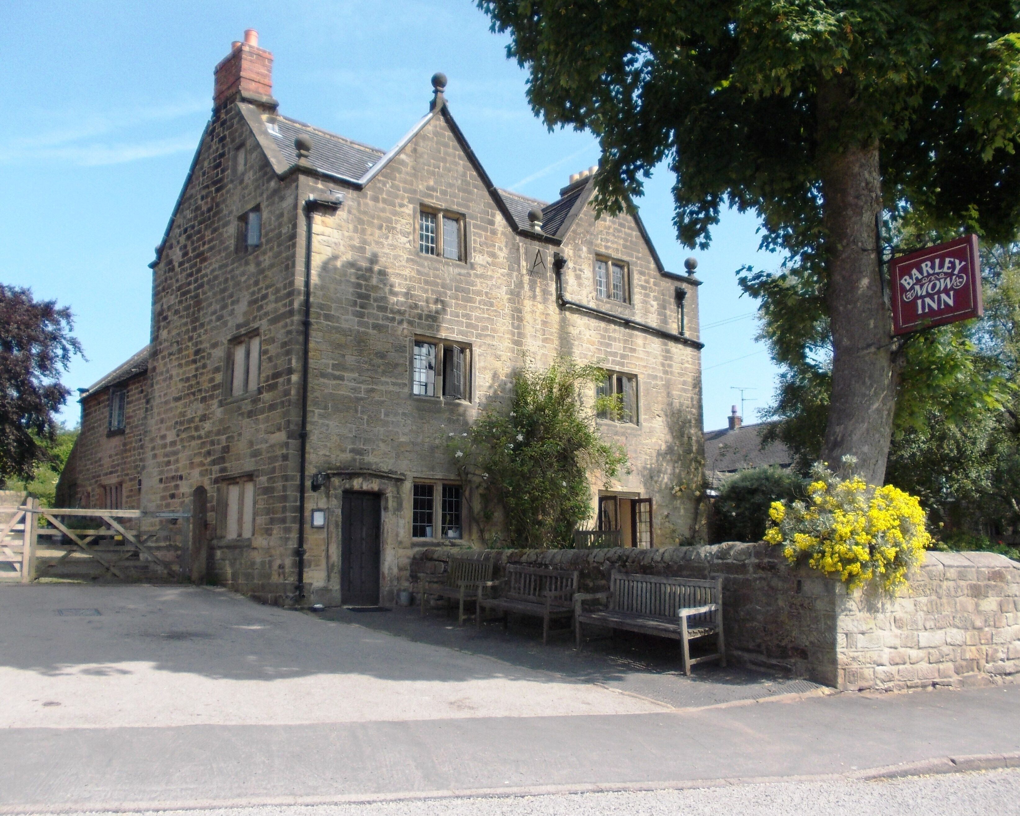 A stone building with a sign for 'Barley Bawley Inn'.
