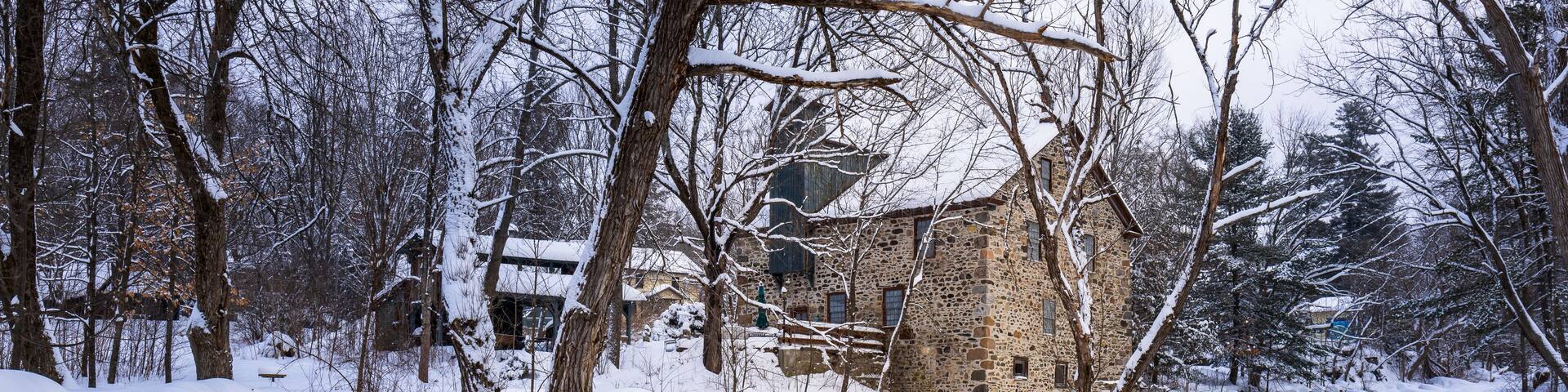 The village of Frelighsburg, in the Eastern Townships, the old stone mill at the foot of the pike river almost completely frozen on a February day