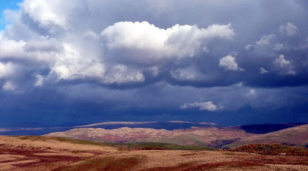Dramatic skies over the Lune Valley, 3 km from Old Town, Cumbria, Great Britain. Strong north-westerly winds were chasing sunlight and shadow over the fells east of the Lune. The long ridge of Holme Knott is in sunlight as is the very top edge of Baugh Fell above it.