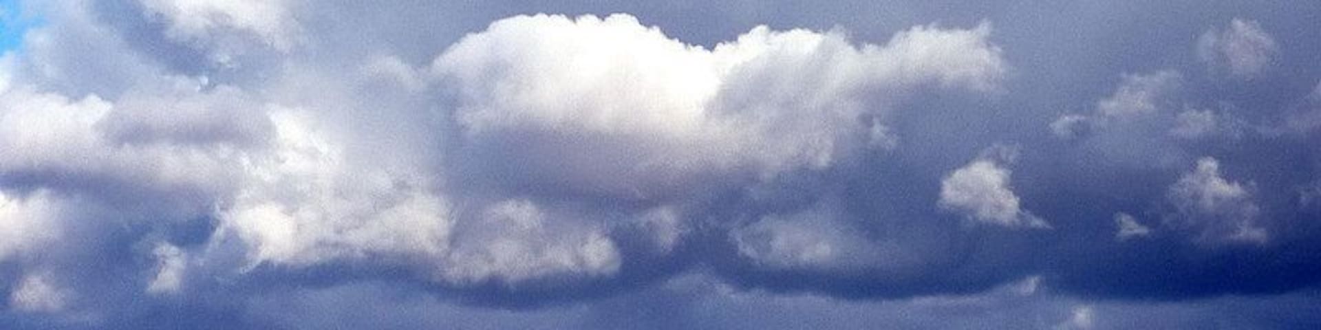 Dramatic skies over the Lune Valley, 3 km from Old Town, Cumbria, Great Britain. Strong north-westerly winds were chasing sunlight and shadow over the fells east of the Lune. The long ridge of Holme Knott is in sunlight as is the very top edge of Baugh Fell above it.