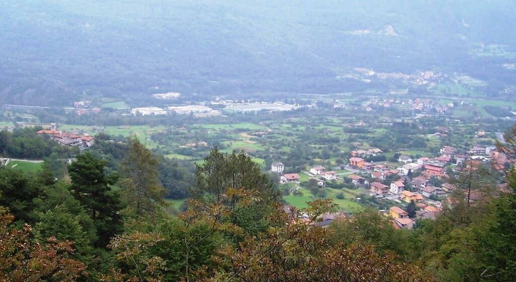 A mountainous landscape with a village nestled in the valley.