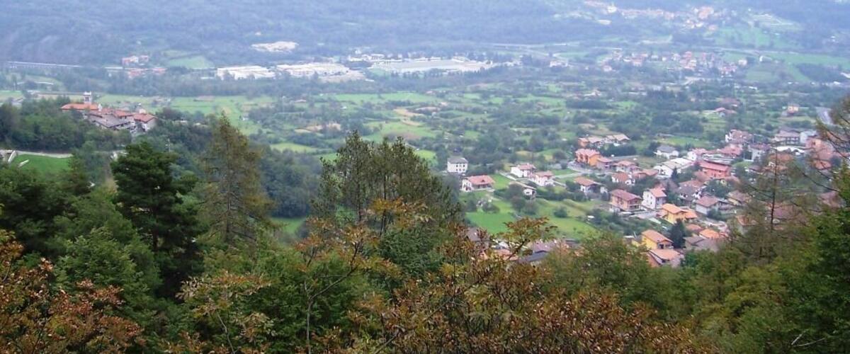 A mountainous landscape with a village nestled in the valley.