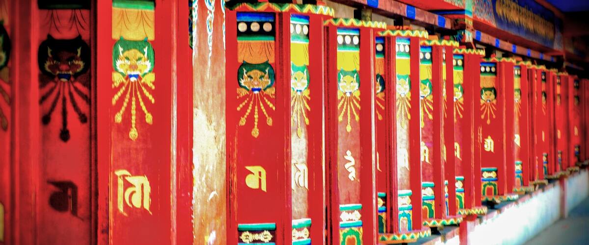 A row of brightly colored, ornately decorated buildings with traditional Tibetan architectural elements.