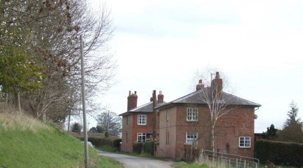 Houses by the Roman Road These matching red-brick houses probably originally housed workers at Home Farm, out of shot to the left. The Roman road here bends around the foot of Garnons Hill.