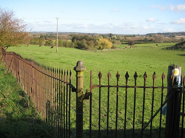 Footpath east from the church Across a dairy pasture. Earlier maps show this as the approach to Withington Court, now approached from the south.