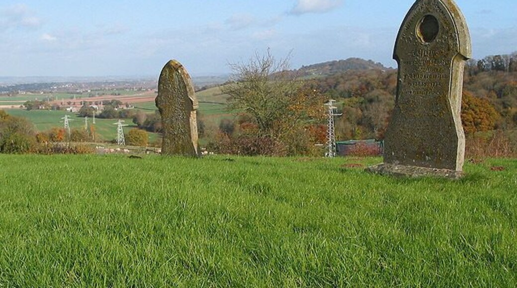 Churchyard of St. Mary's, Callow Maybe it's the altitude but there are very few graves in the churchyard. Power lines can be seen stretching into the distance with Ridge Hill visible between the two gravestones.