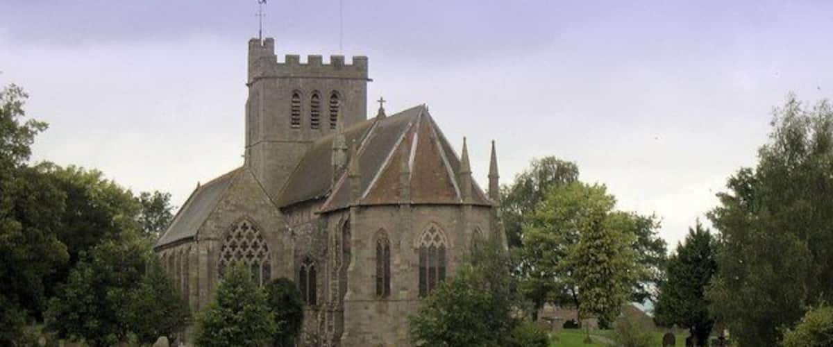 A historic church with a prominent tower and arched windows.