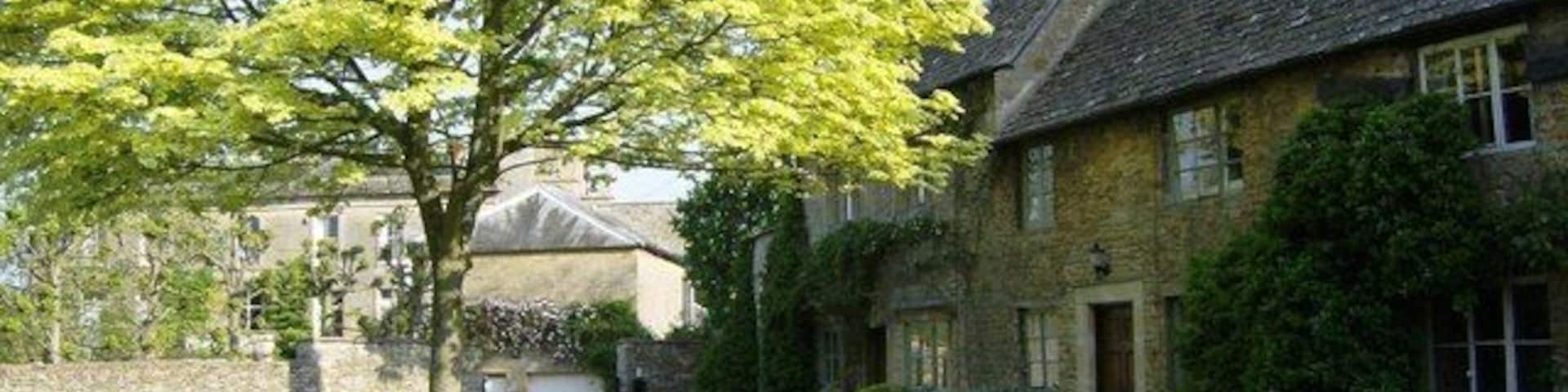 Lower Oddington green With Oddington House behind.