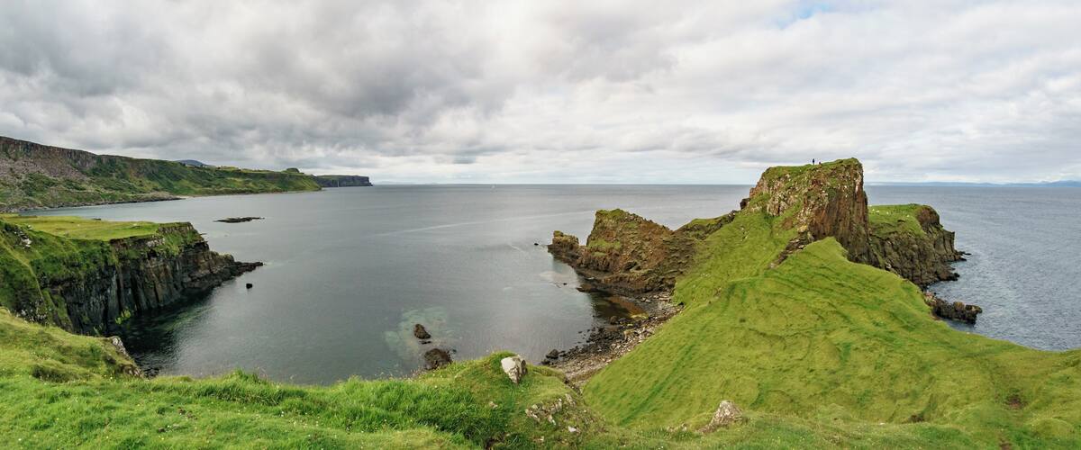 A coastal landscape with cliffs and a body of water.
