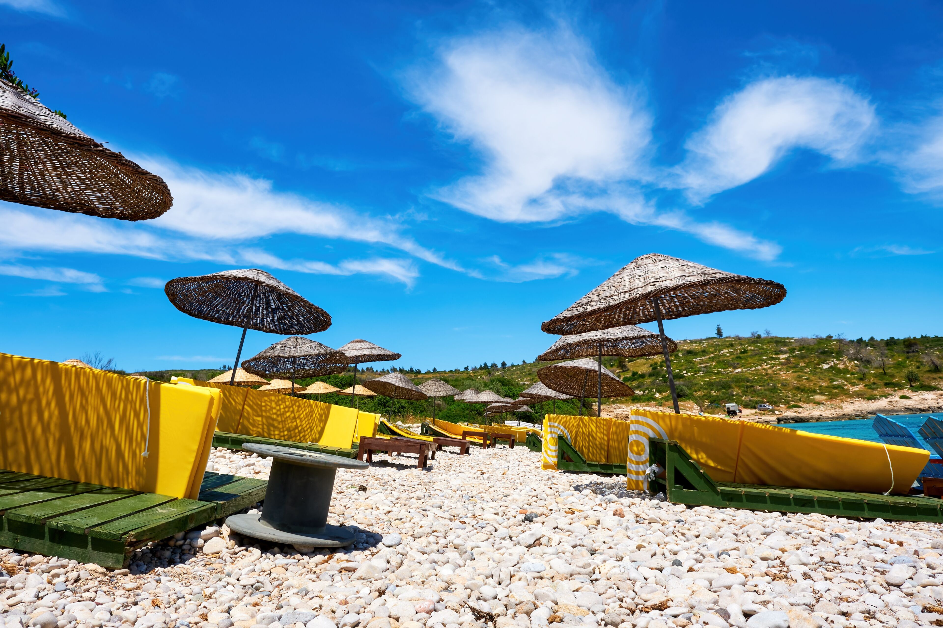 Beach, sea, sunbeds and sky. Holiday or travel destinations.