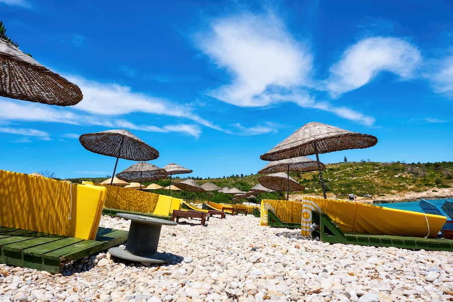 Beach, sea, sunbeds and sky. Holiday or travel destinations.