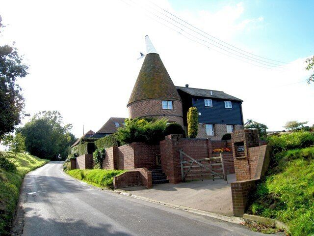 Catt Oast, Catt's Hill, Stone In Oxney, Kent. Single round kiln oast house, converted in 1984. The vane icon on the cowl depicts a cat inspecting its paw 1509964 Keywords: cat, roundel, conversion, hop drying, beer, black weatherboard, cowl