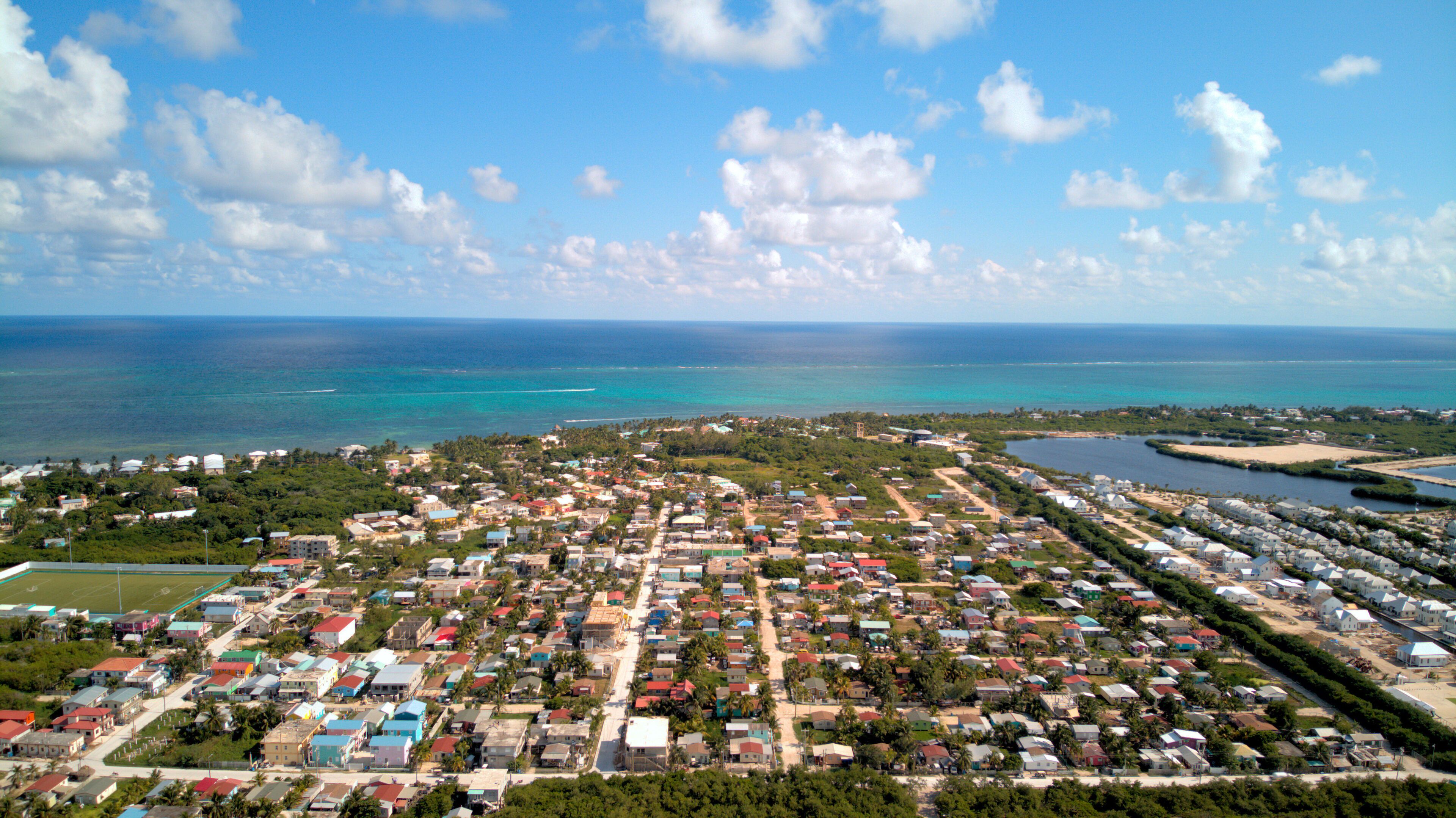 A coastal town with colorful houses, a beach, and the ocean.