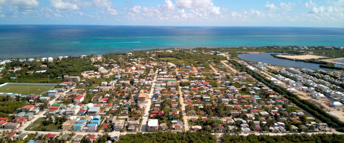 A coastal town with colorful houses, a beach, and the ocean.