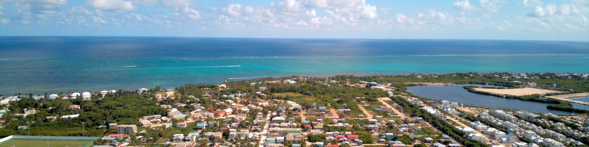 A coastal town with colorful houses, a beach, and the ocean.
