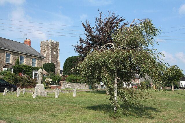 Coldridge: village green. The church is dedicated to St Matthew, but between 1742 and the late 19th century it was St Marys. Out of shot, on the south side of the green are The Old Post Office and The Old Bakery indicating that the village was a little more self-sufficient in earlier times. Looking east-north-east