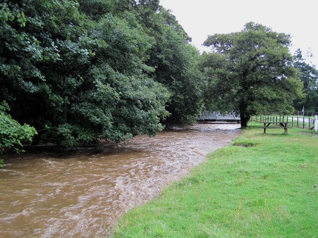 Manor Water in spate near Kirkton. After several days of intermittent rain culminating in a wet night, the water level is not very far below the bank which protects the road on the right. Compare with 1197956.