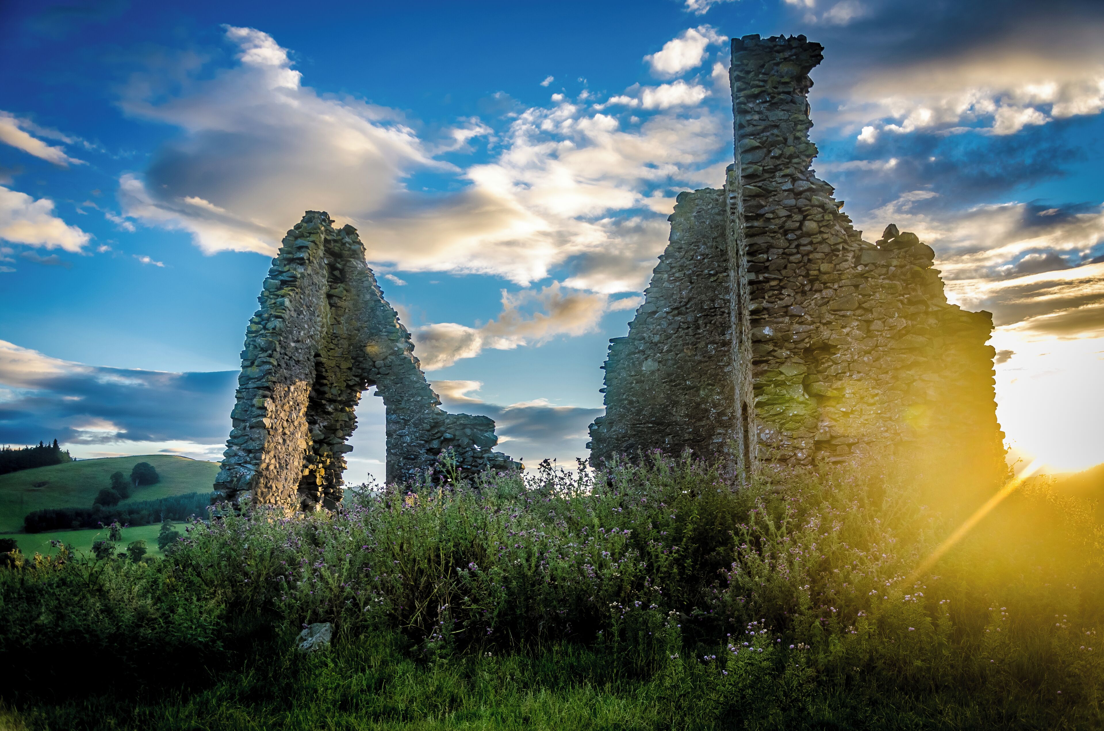 Ancient stone ruins with a clear sky and sunlight.