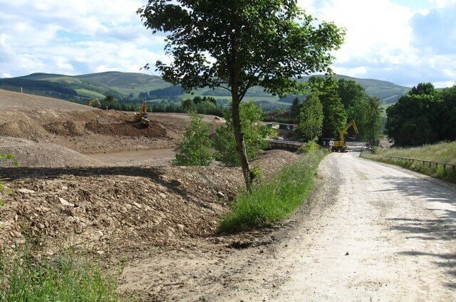 The road leaving the Glentress Forest behind The road near the exit to Glentress Forest goes through much activity as new roads and paths are being constructed at the foot of the hills near Eshiels.