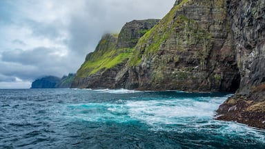A rugged coastline with steep cliffs and turbulent sea waves.
