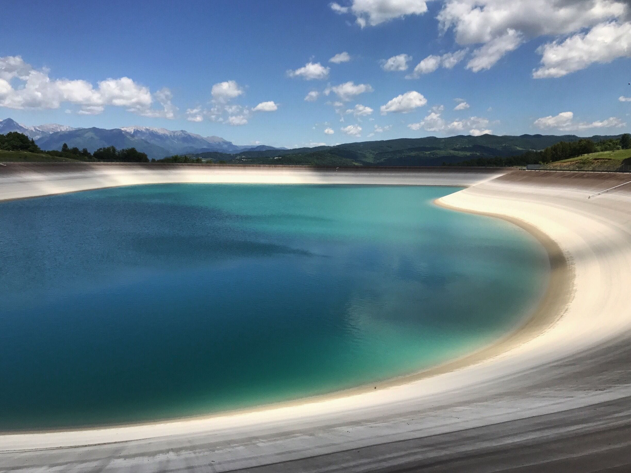 human made lake and nature in background. 