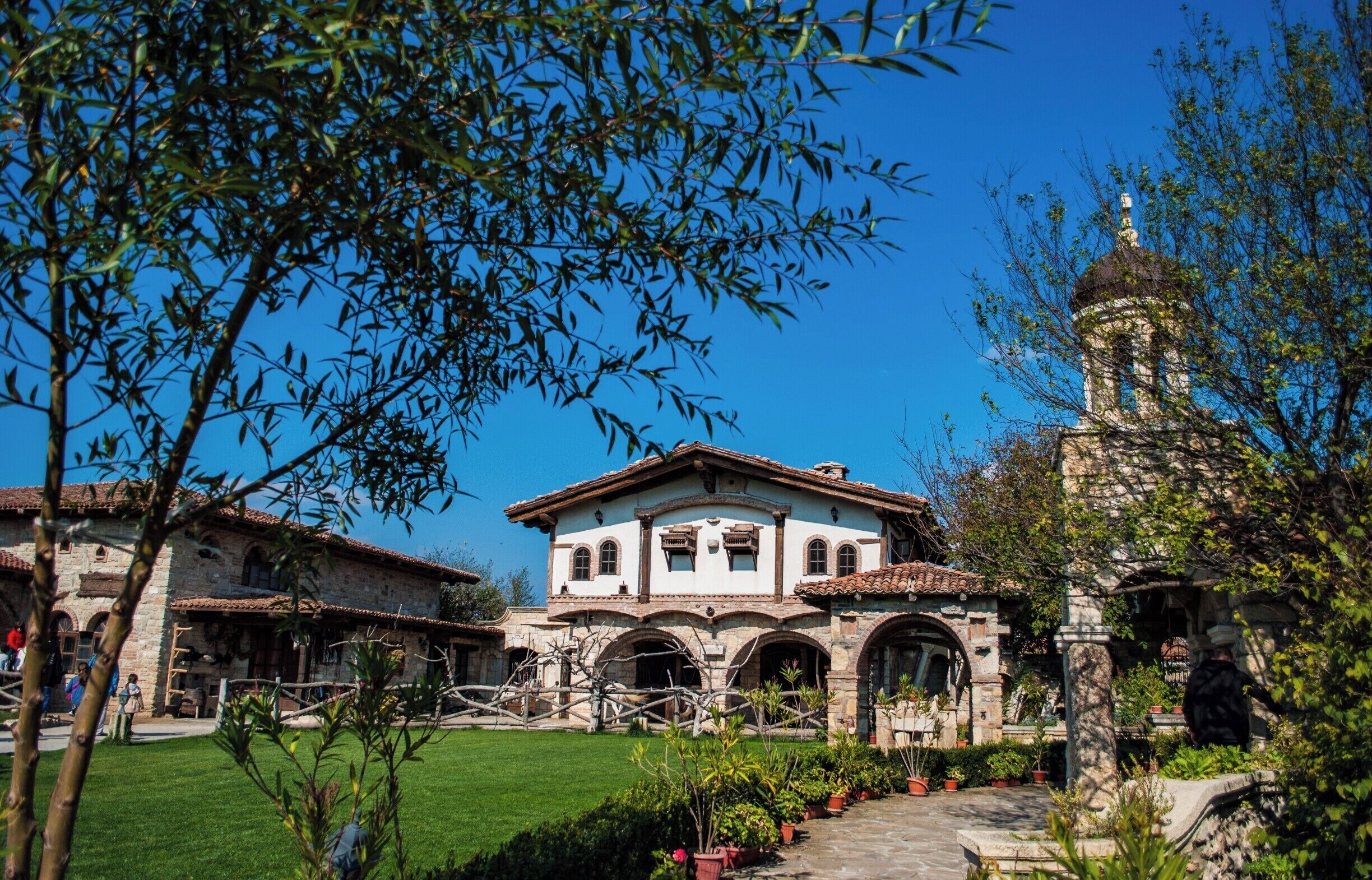 A historic building with a tiled roof, arched windows, and a bell tower.