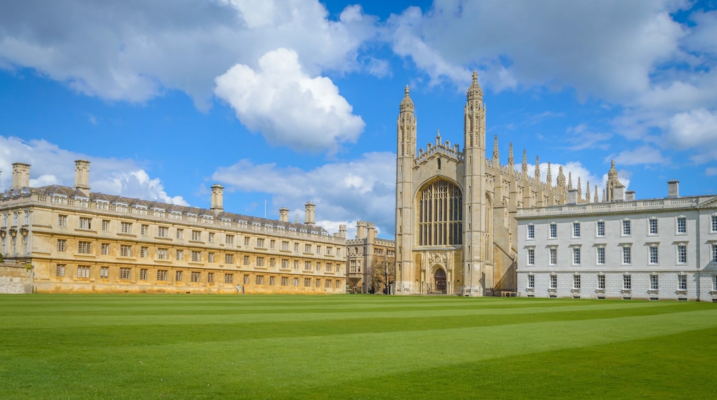 A historic university campus with a prominent Gothic-style building and a well-maintained lawn.