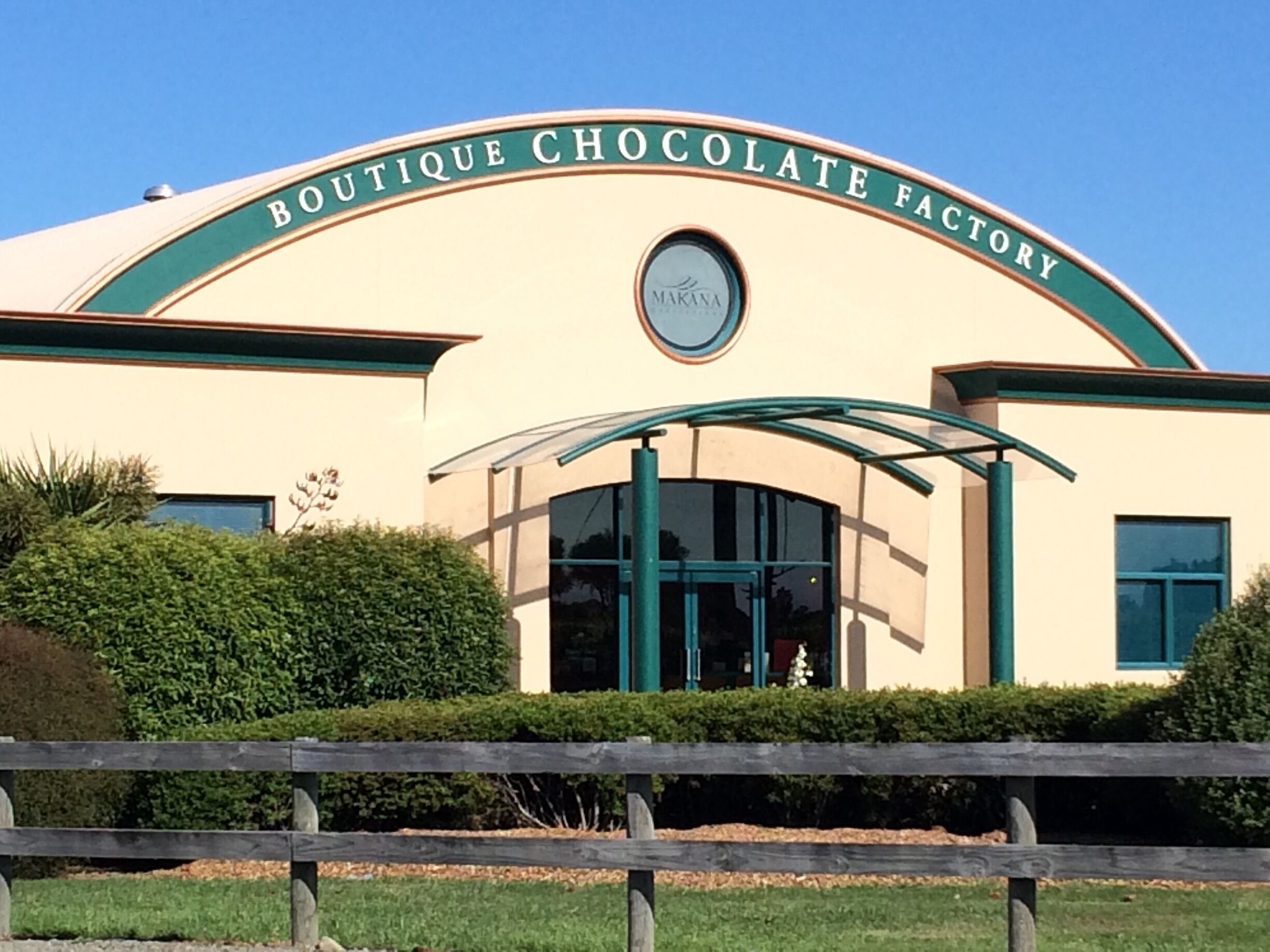 A building with a sign that reads "Boutique Chocolate Factory" and a Makana logo.