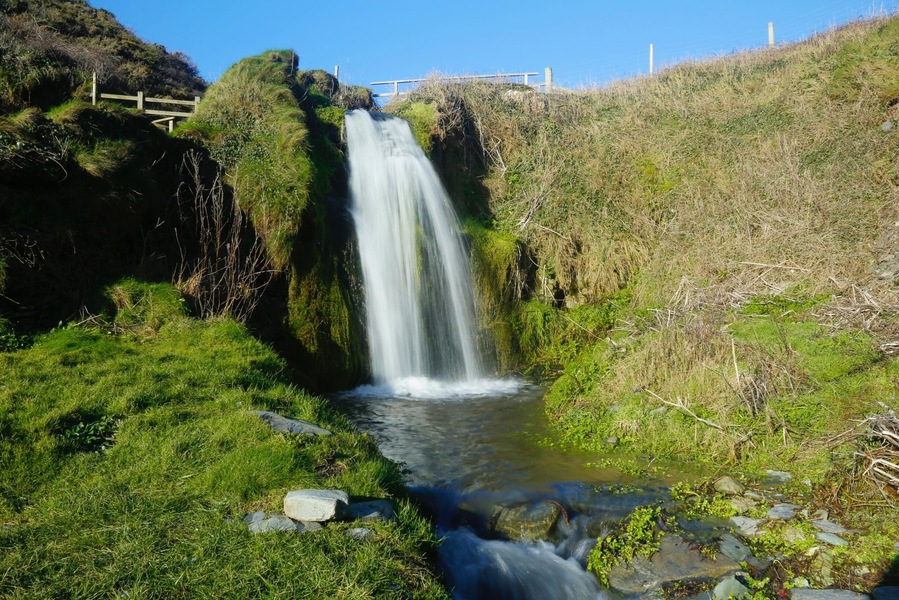 On the beach there is a waterfall, which can only be seen after heavy rain fall. There is a great walk through some woods from the main car park by the church to get to this amazing crescent shape cove where you will find this waterfall. A pebble beach offers a great swimming area and a quite place to take some great pictures.