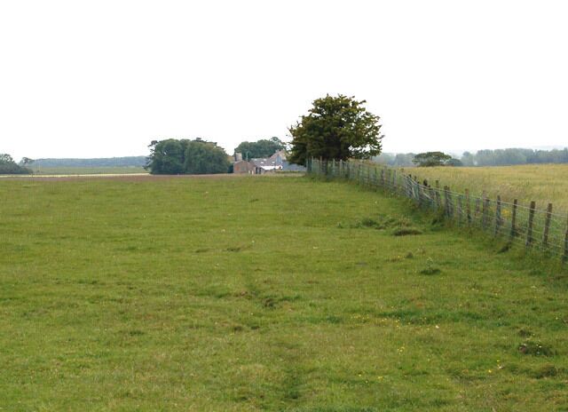 The Shaw seen from near Cheeveley The B6345 crosses the northwest corner of the grid square. This photograph is looking south towards The Shaw [1] and it was taken in the field south of the B6345.