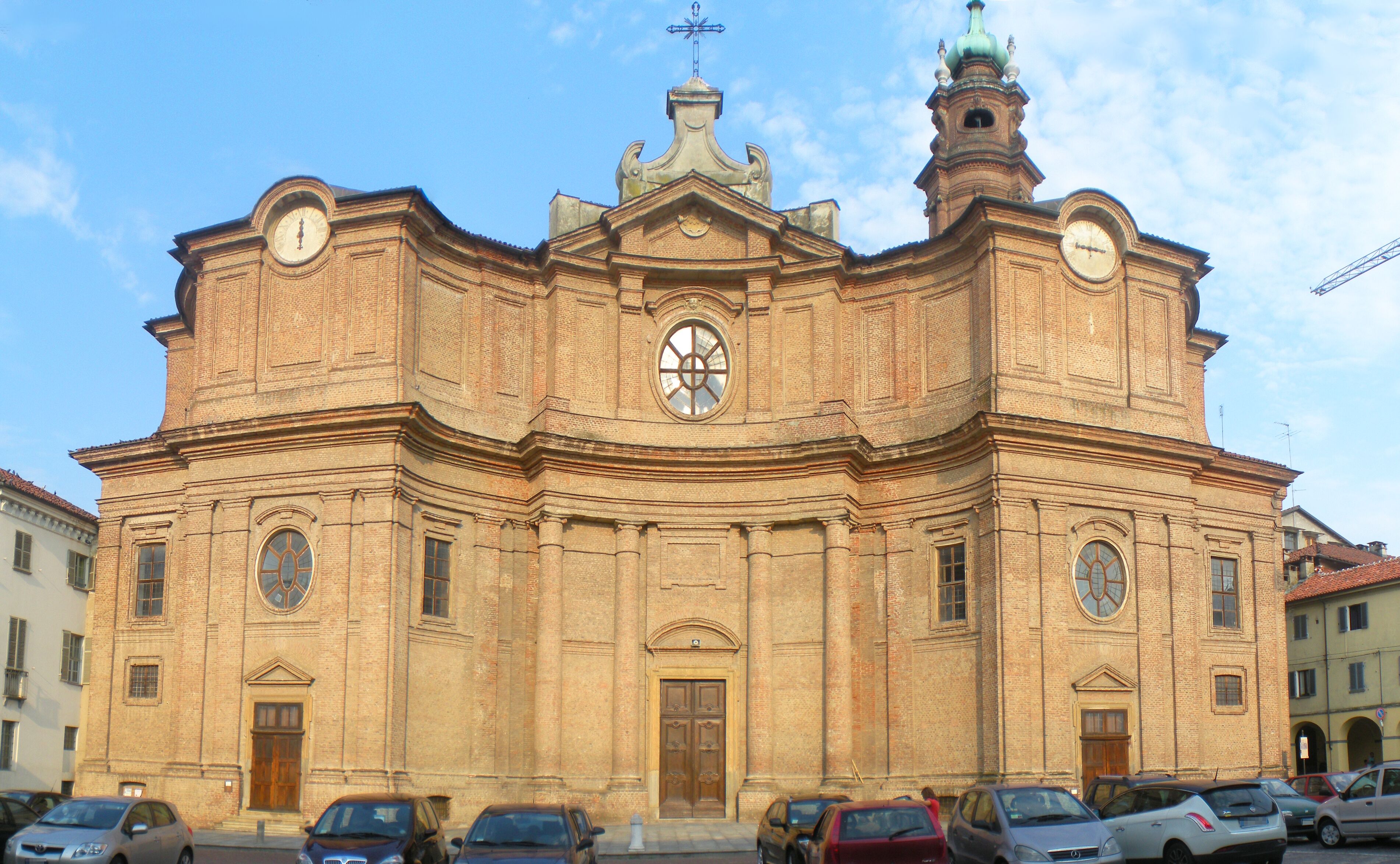 A historic church with a prominent clock tower and a central dome.