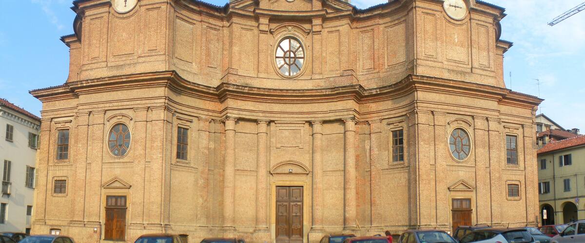 A historic church with a prominent clock tower and a central dome.