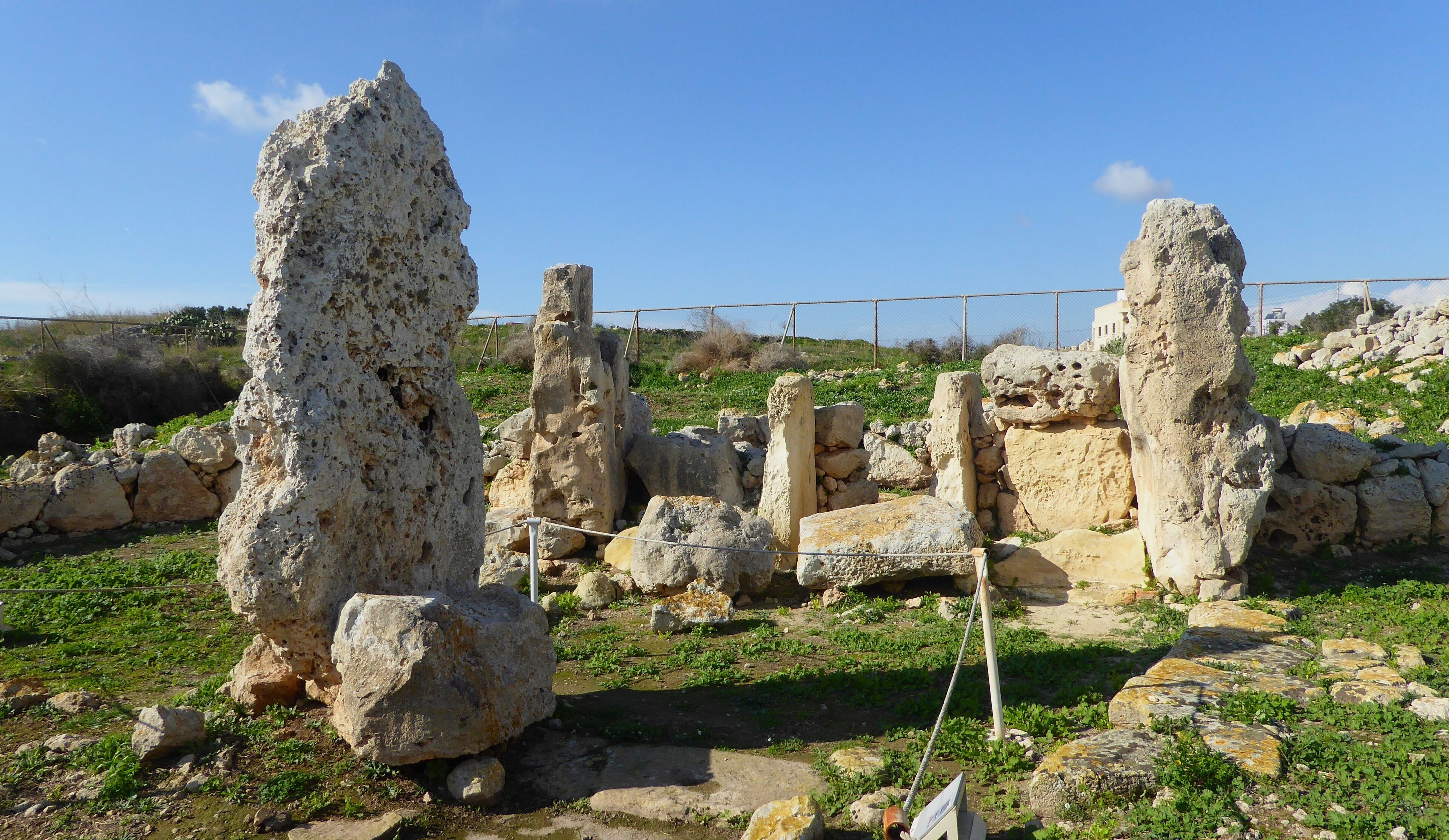 Ancient ruins with large stone structures and scattered rocks.