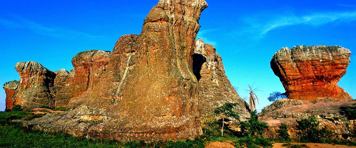 A large rock formation with a prominent cave-like opening.