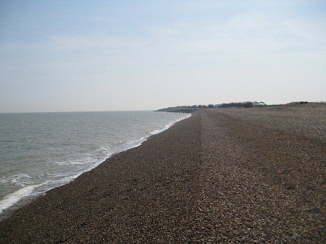 Looking along Bawdsey Beach against the light The headland is covered in sea defences (just visible) but this area of the beach is unspoilt.
