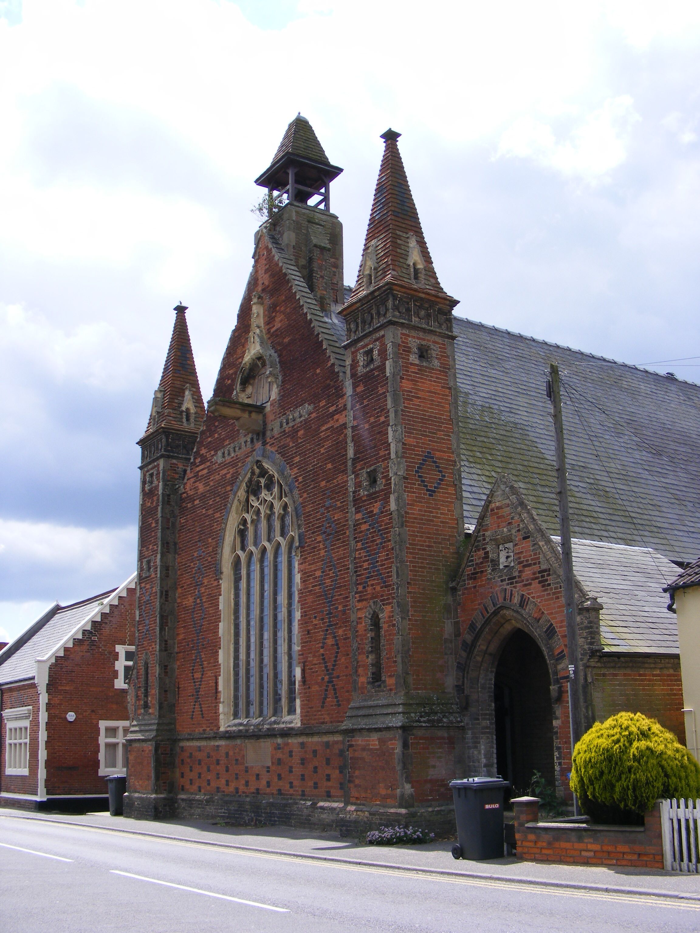 A historic church with a large arched window and multiple spires.