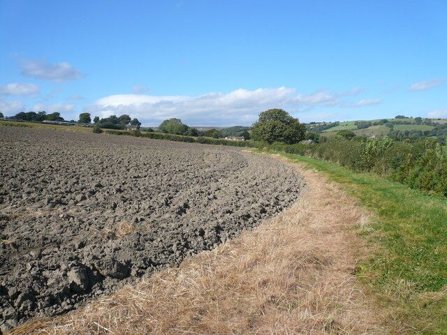 Footpath view across ploughed field Farmhouse on Unthank Lane can be seen in the distance.