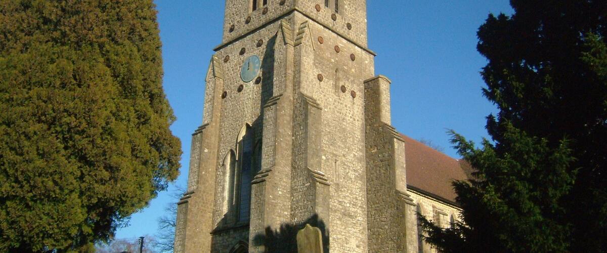 A historic church with a tall tower and arched windows.