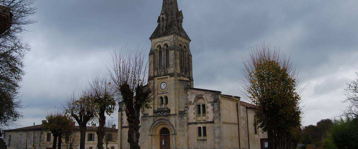 A historic church with a tall spire and a clock tower.