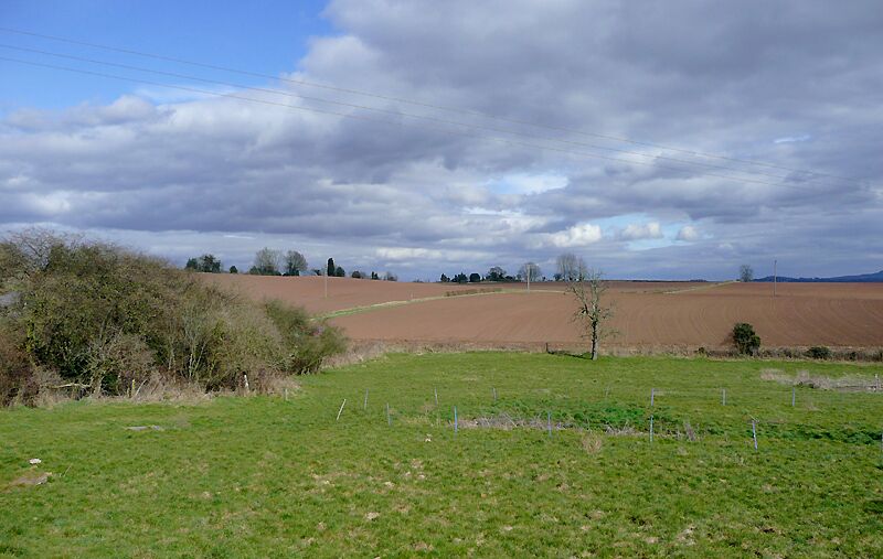 Farmland at Blakeshall, Worcestershire The reddish colour of the soil is due to the Bunter sandstone rock and pebble beds of the area.