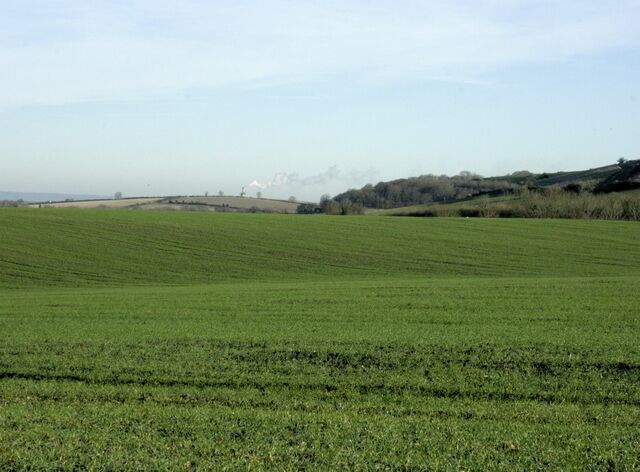 North north east near Upton Scudamore Taken from the lane to Biss Bottom. The Lafarge Cement Works chimney ST8852 can be located by its emissions, water vapour I think rather than smoke. To the right we have the northern end of Upton Cow Down.